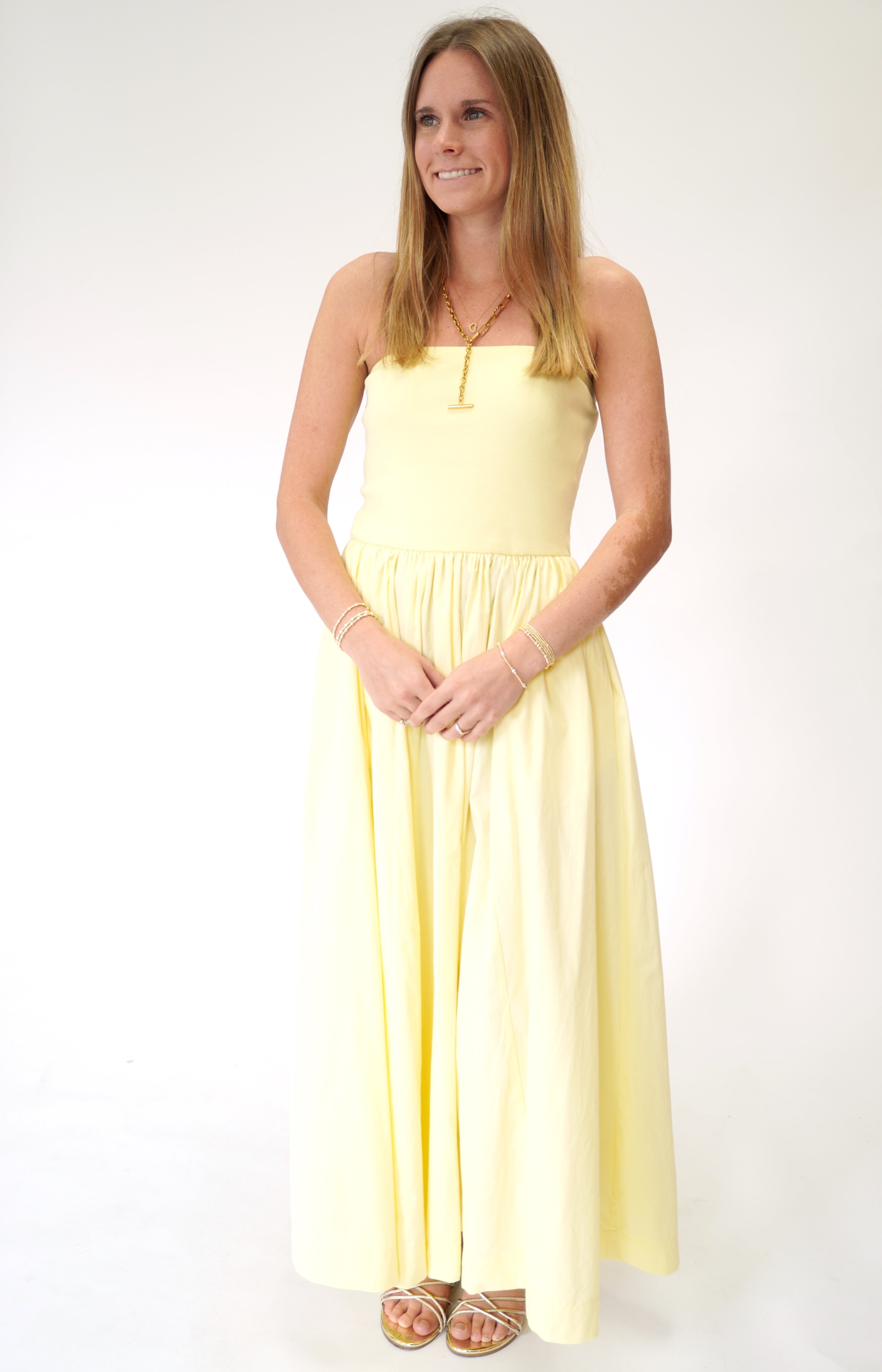 Bright butter yellow strapless maxi dress with feminine flowy design perfect for warm weather.