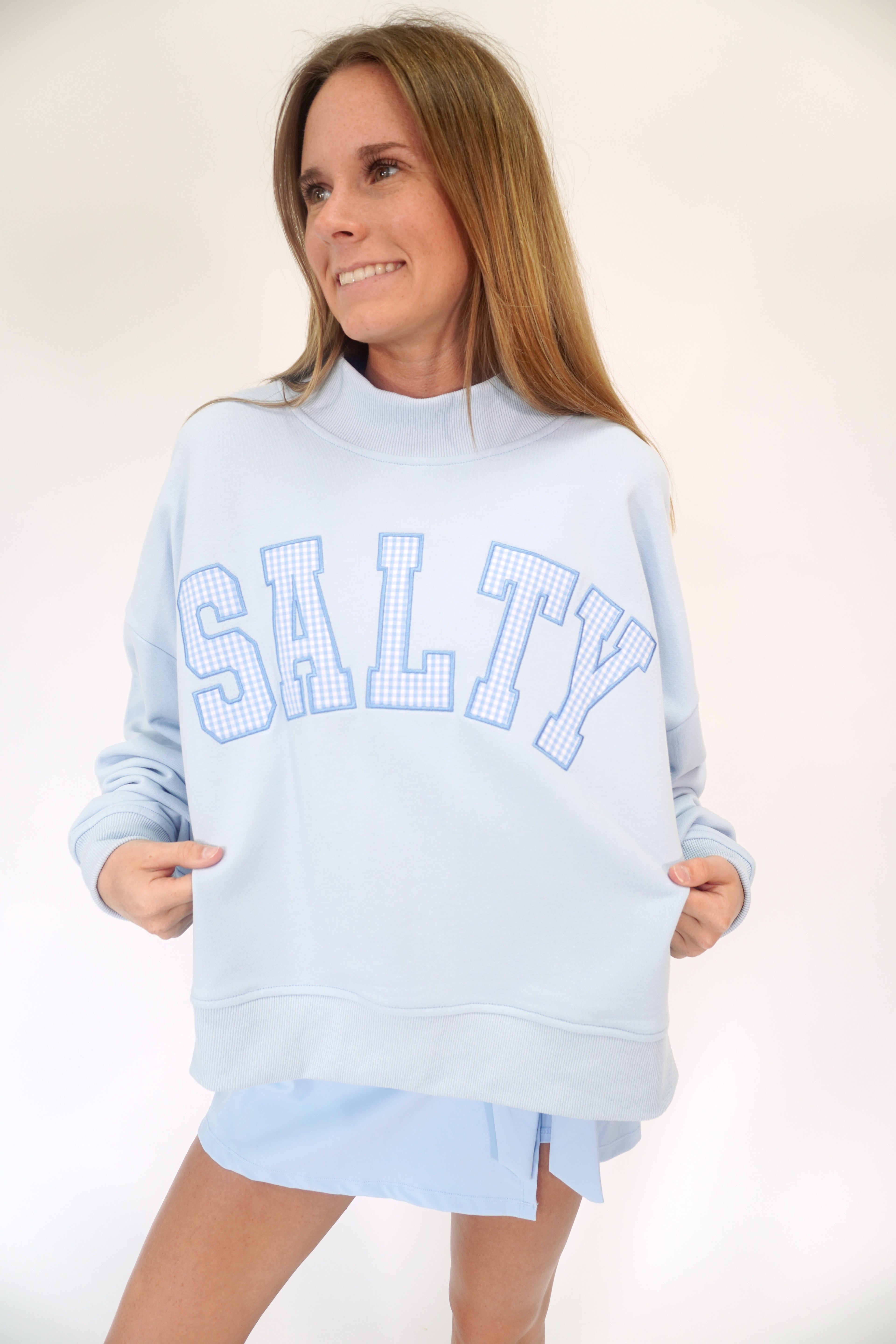 Coastal blue mock neck sweatshirt with gingham “SALTY” graphic and cozy lounge style.