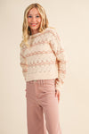 Side view of girls cream striped open-knit sweater with long sleeves