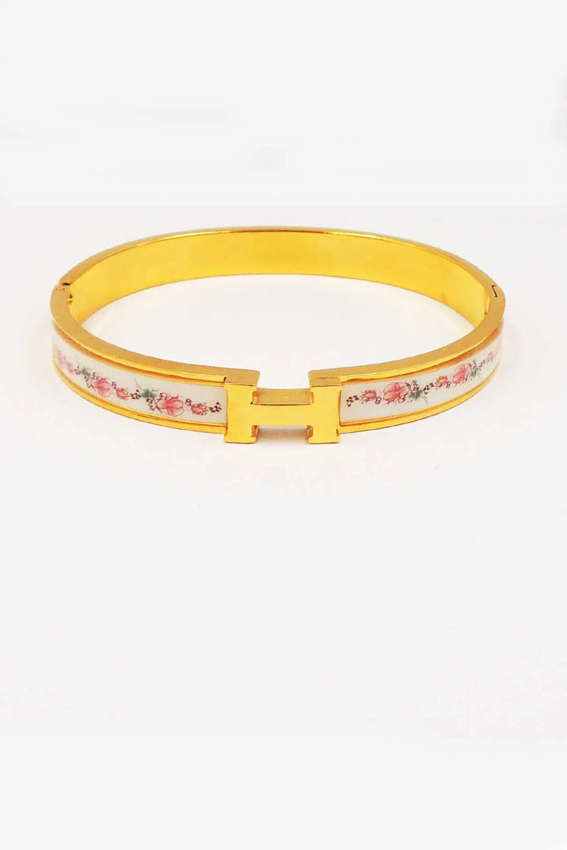 Yellow bracelet with floral pattern on a white background