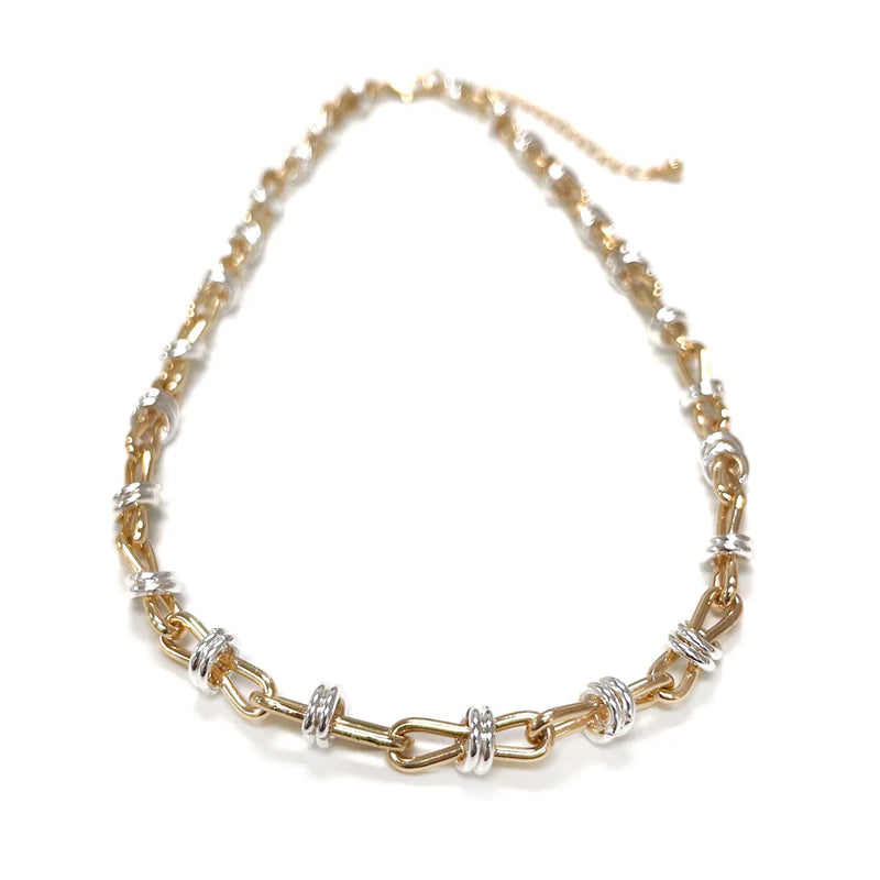 Gold and silver chain necklace on a white background