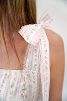 Spring-ready pink printed midi dress with bow tie straps and full silhouette