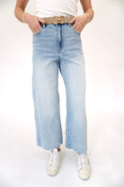 Light wash Hidden brand cropped wide leg jeans with high-rise waist and relaxed fit.