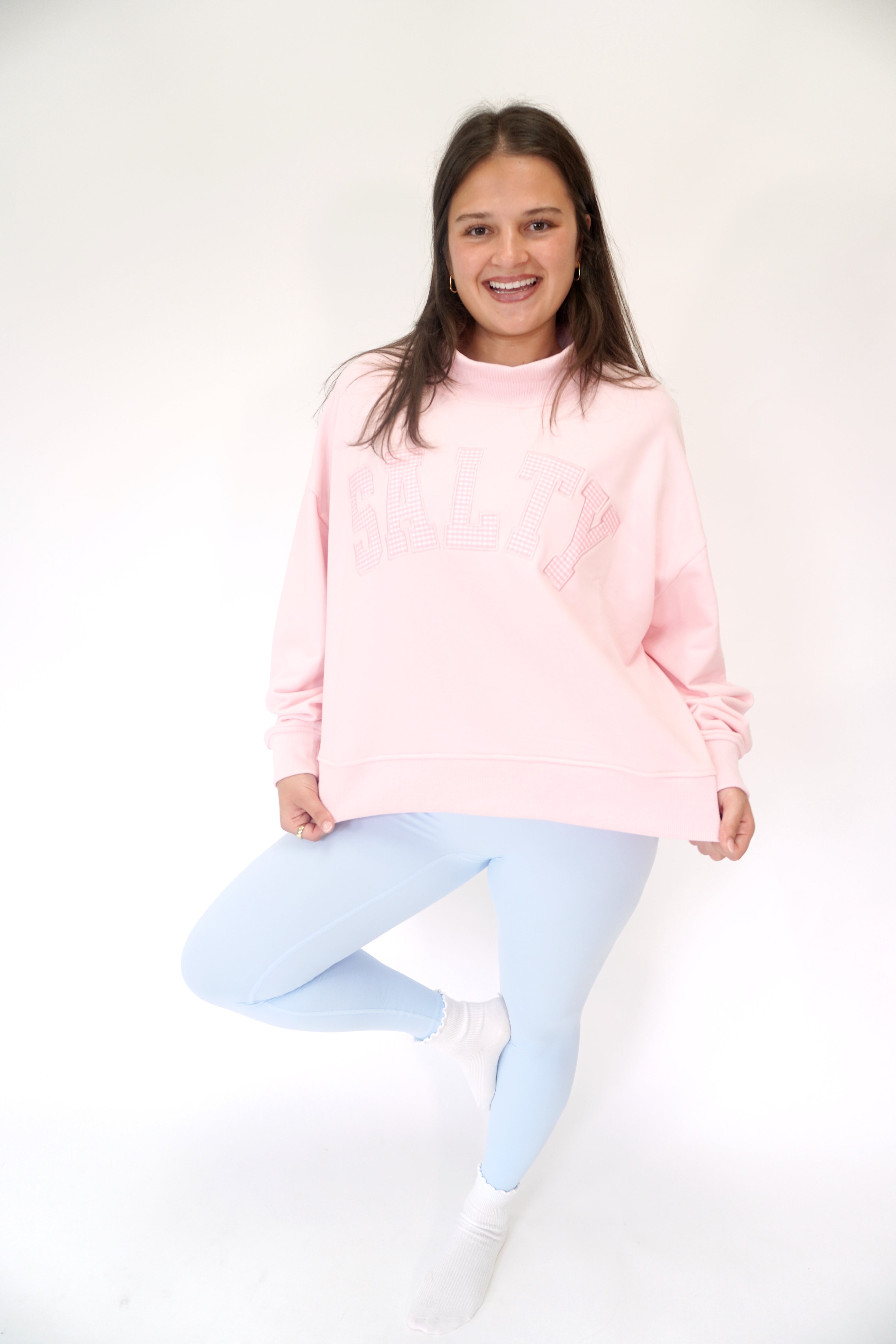 Cozy blush pink mock neck sweatshirt with SALTY graphic and laid-back coastal vibe.