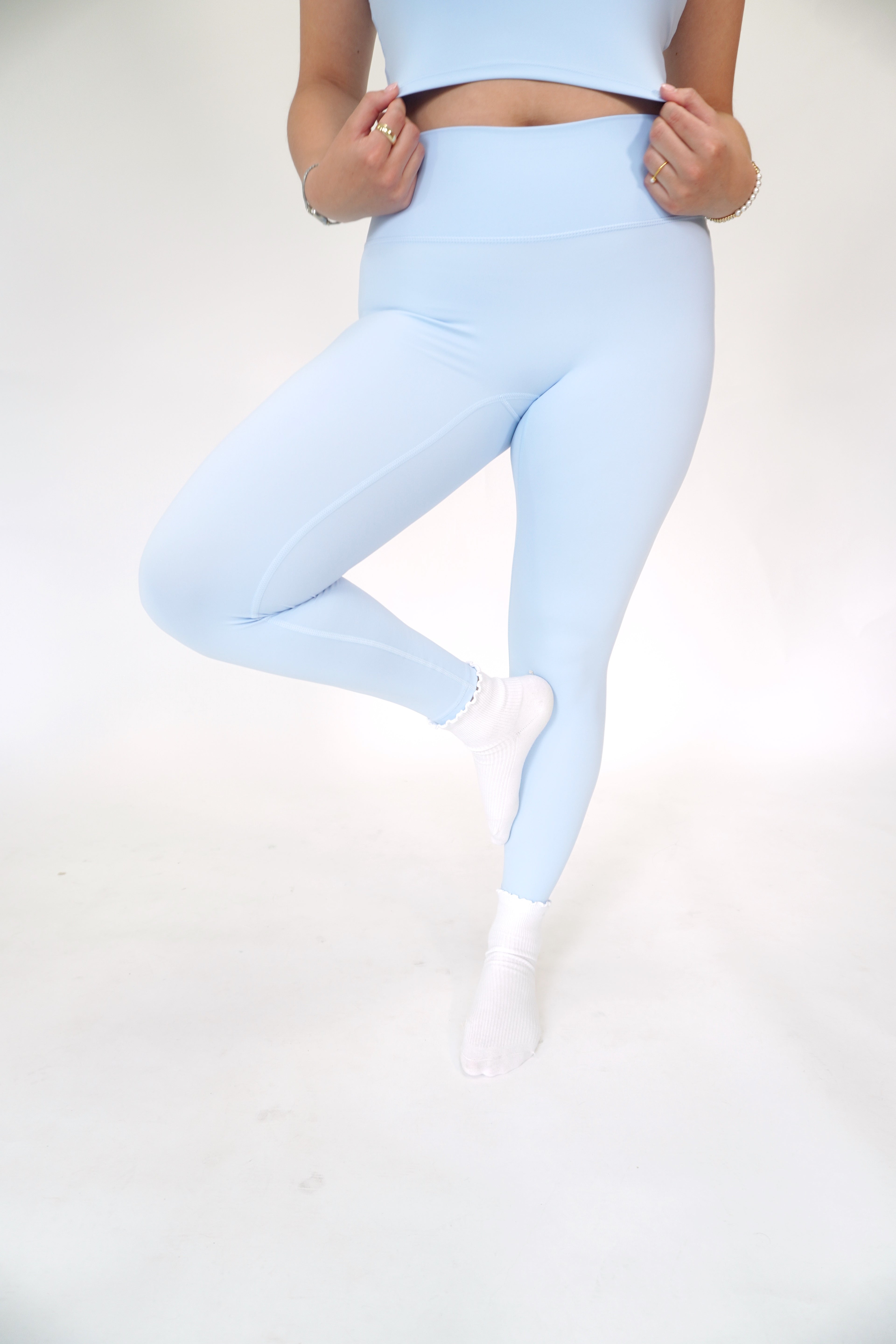 Light blue performance leggings with high-rise waistband and ultra-soft activewear fabric.