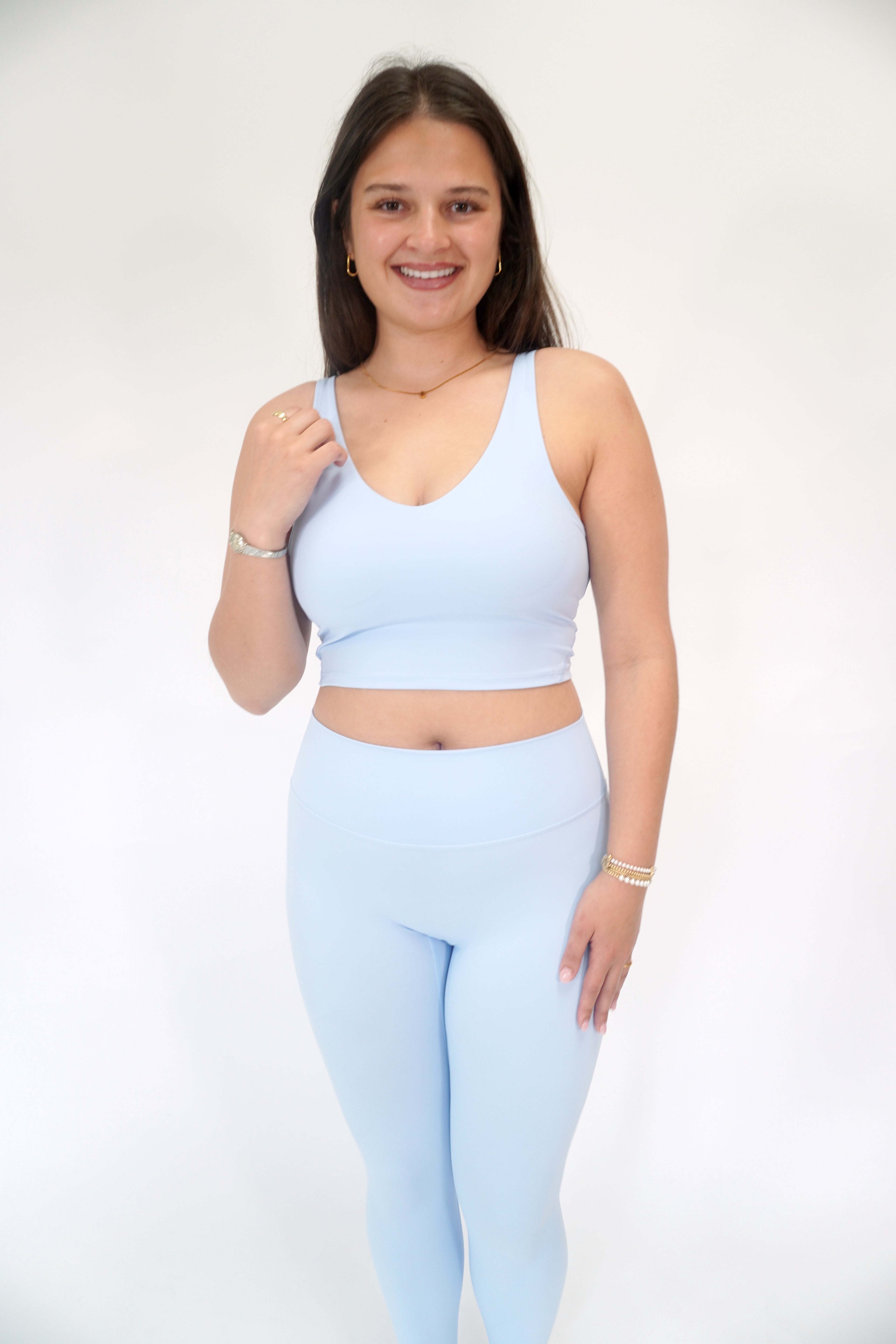 Light blue buttery soft athletic bra with scoop neck and comfortable performance design.