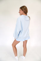 Pastel blue mock neck SALTY sweatshirt with ribbed cuffs and comfortable oversized fit.
