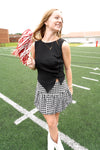 Woman holding pom-poms on a football field