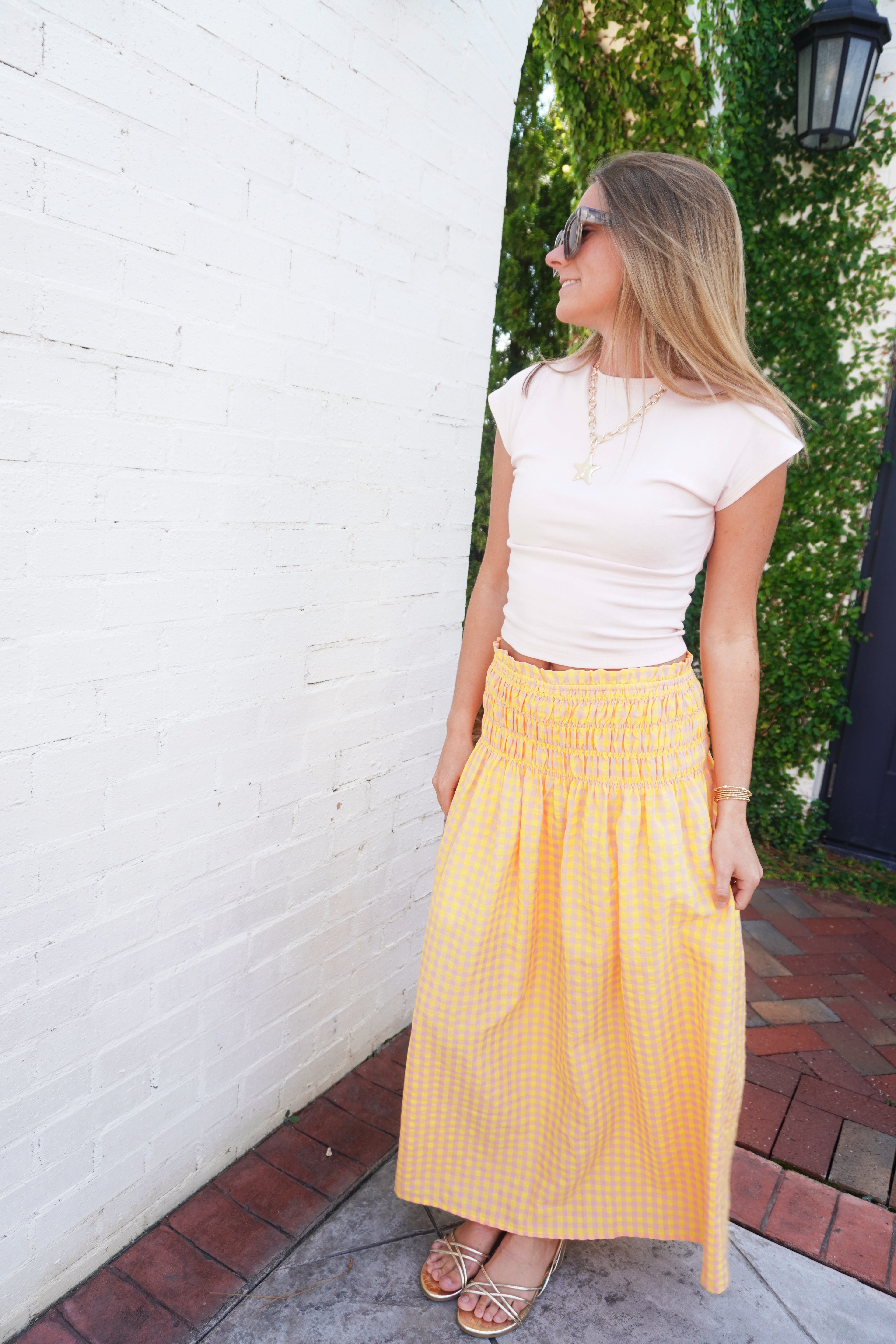 Cream fitted cap sleeve top with soft stretch fabric styled with a gingham skirt