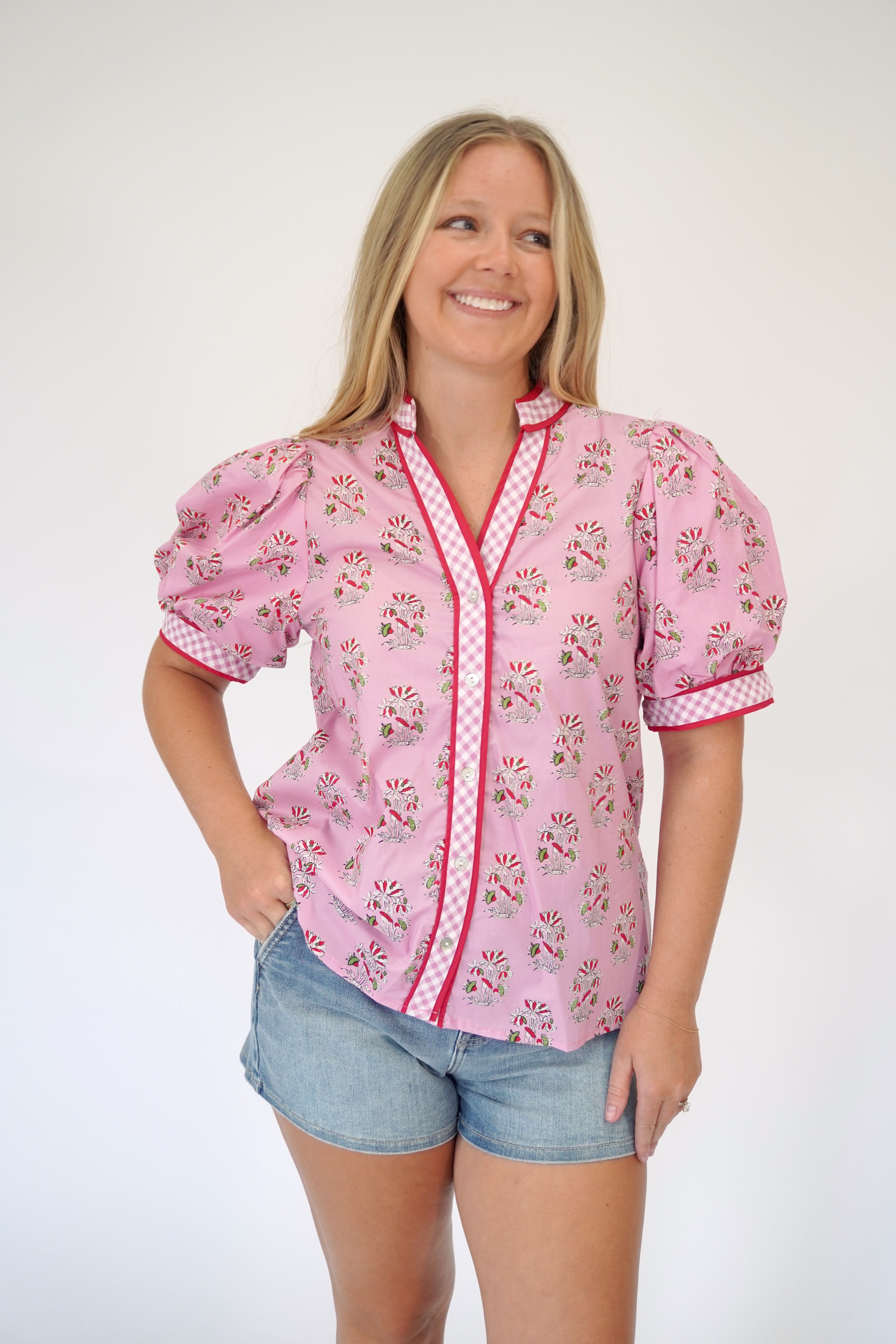 Summer pink blouse with puff sleeves and button front paired with denim shorts