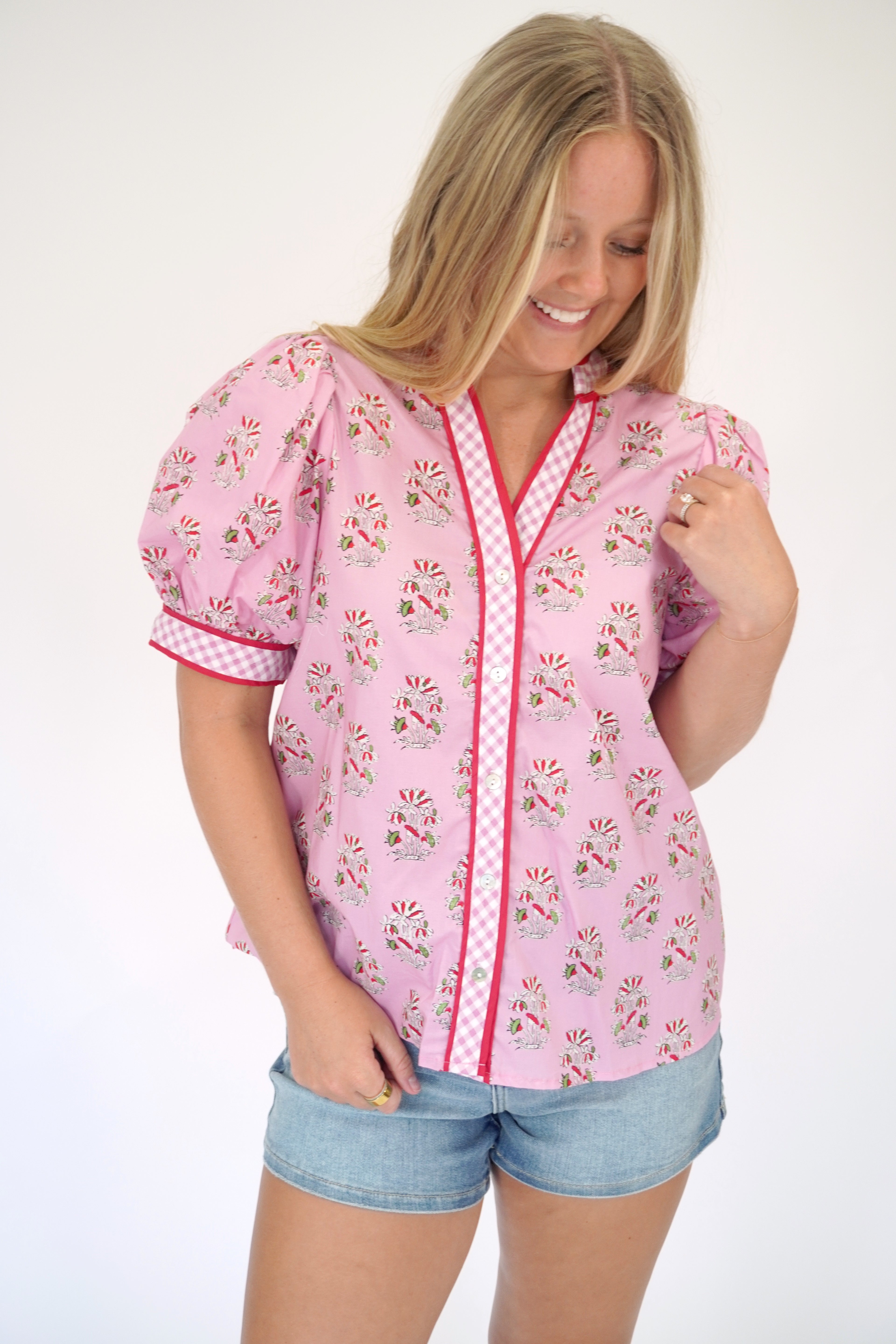 Women’s pink printed top with short puff sleeves and contrast gingham accents