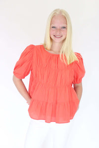 Sunset Breeze Tiered Babydoll Top - Coral Orange both hands on pocket