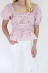 Mauve Elegance Peplum Top details hands in pockets