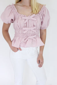 Mauve Elegance Peplum Top details hands in pockets
