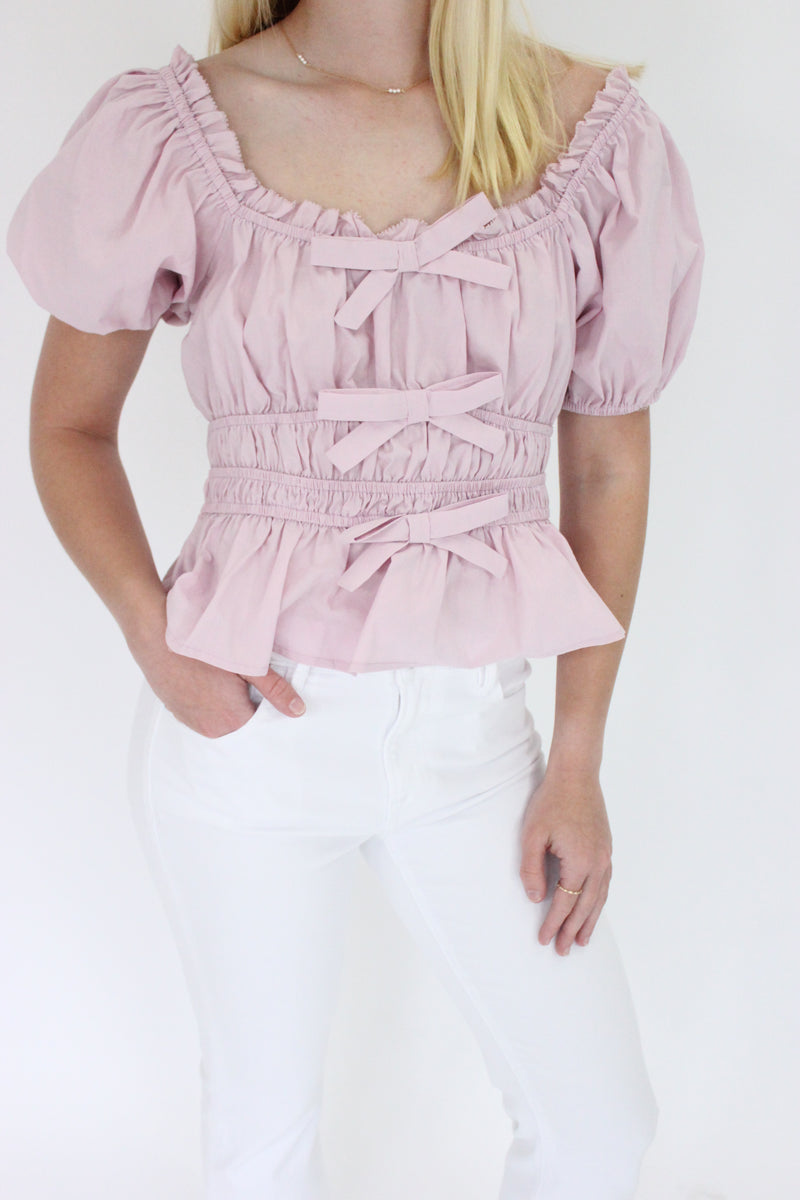 Mauve Elegance Peplum Top details hands in pockets