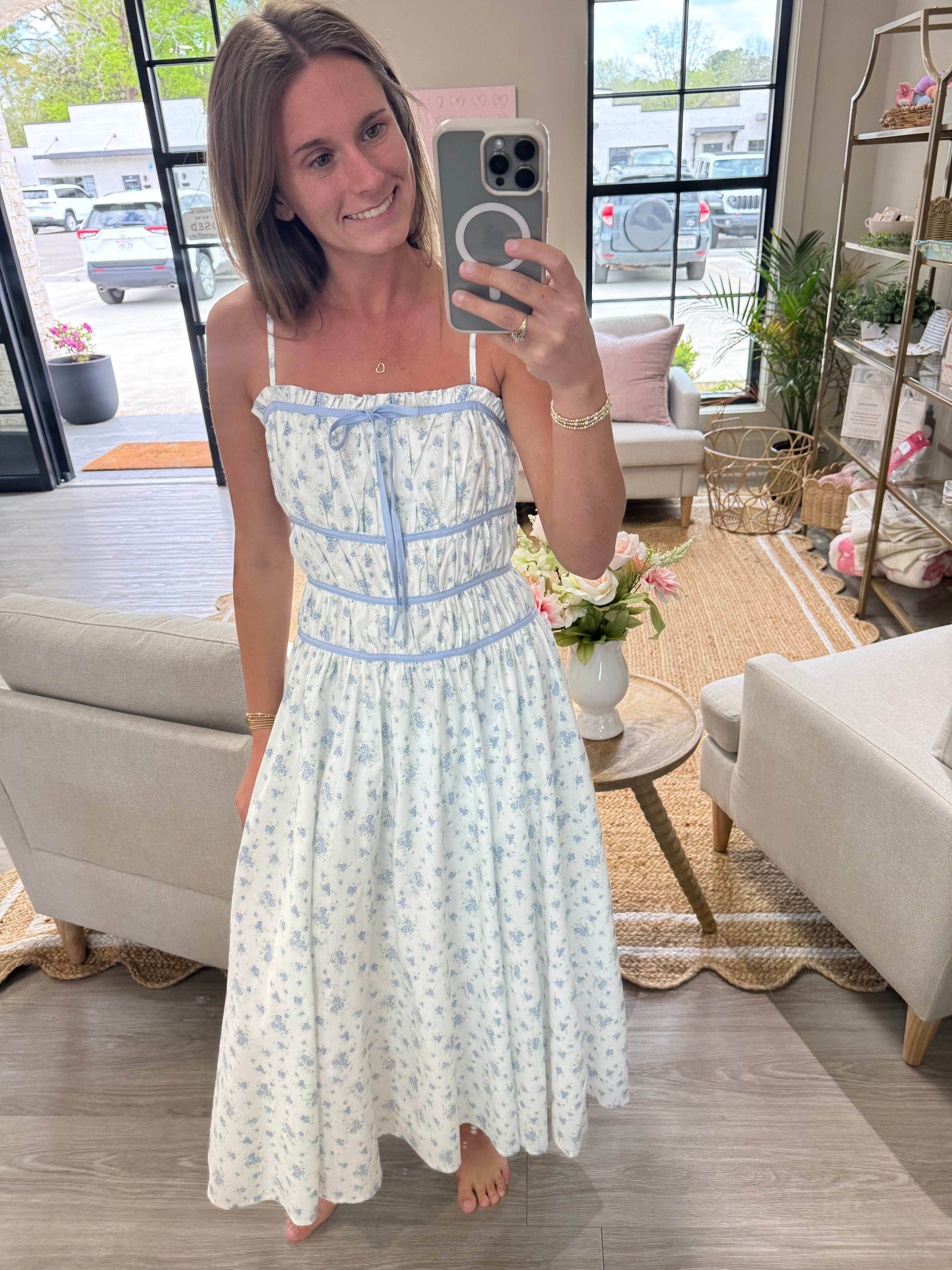 Blue and white floral midi dress with structured bodice and breezy spring-ready fit.
