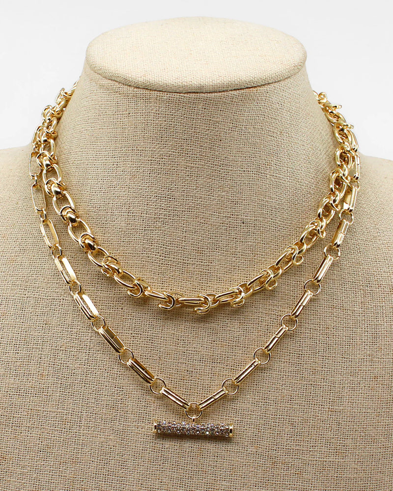 Gold chain necklace on a beige mannequin bust
