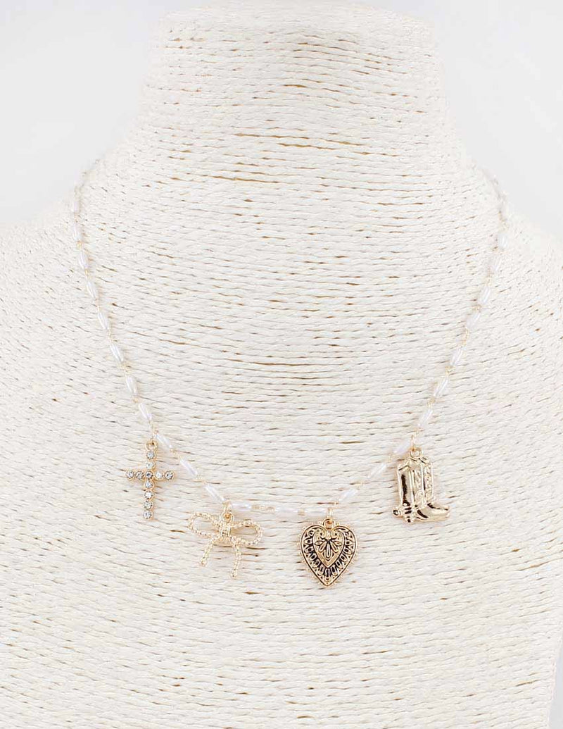 Set of gold necklaces with various pendants on a textured white background