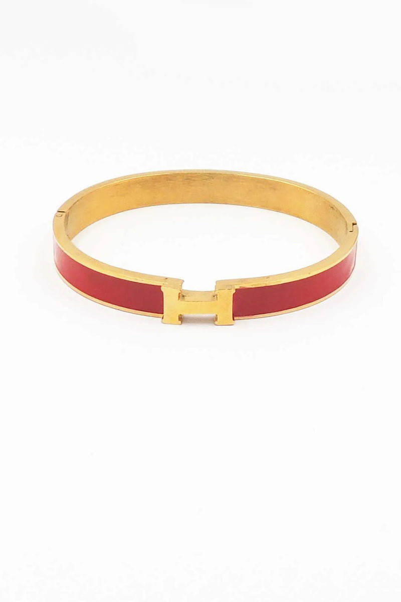 Gold and red bracelet on a white background