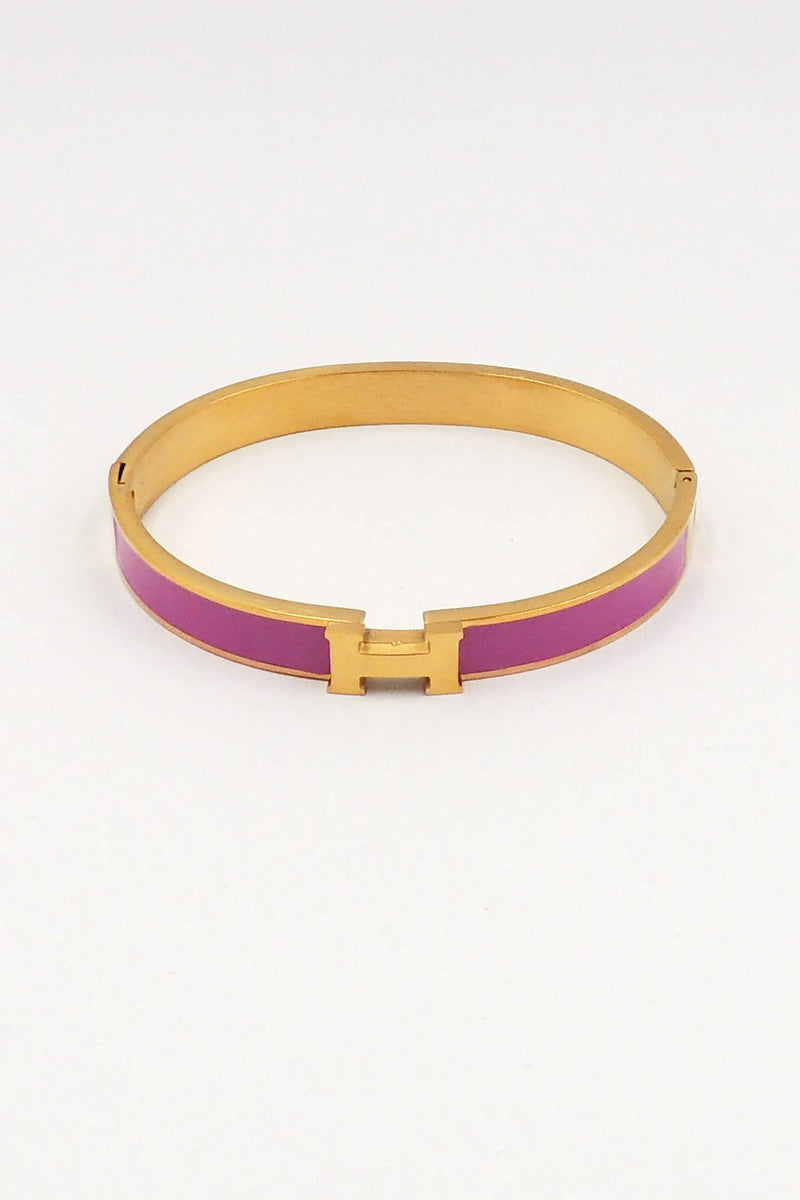 Gold and purple bracelet on a white background