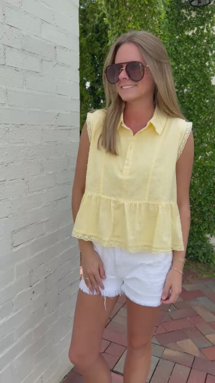 Women’s pastel yellow summer top with textured fabric and flowy peplum silhouette