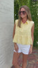 Women’s pastel yellow summer top with textured fabric and flowy peplum silhouette