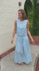 Light blue sleeveless boutique top with navy polka dots styled for a polished summer look.