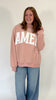Faith-based pink sweatshirt with oversized fit and bold WWJD graphic
