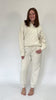 Women wearing a cream quilted pullover with 3/4 zip neckline and relaxed silhouette