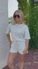 Lightweight green striped terry cloth set styled with white sandals for an easy everyday look